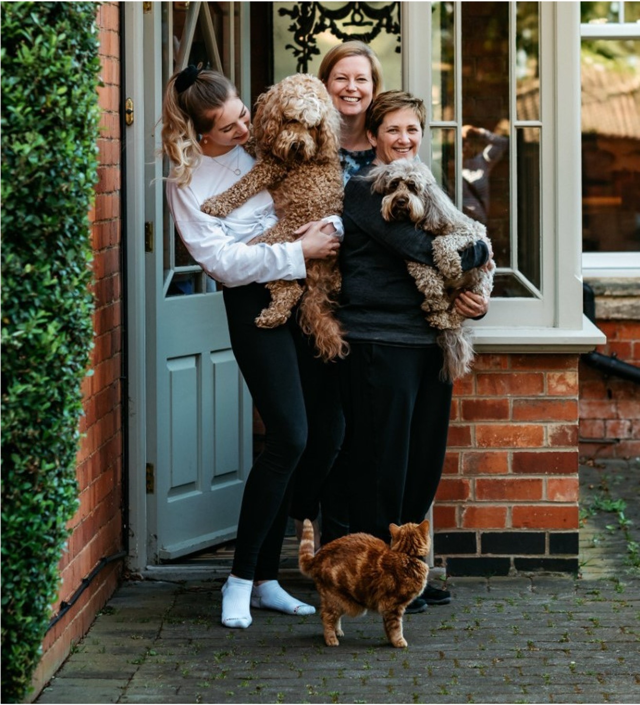 Edel with her partner, daughter and pets on the doorstep at home